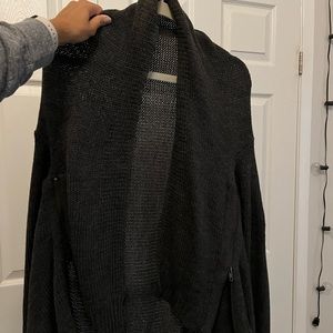 Dark grey sweater with zippers on the sides and leather patched elbows.